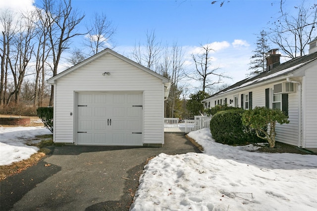 detached garage featuring aphalt driveway