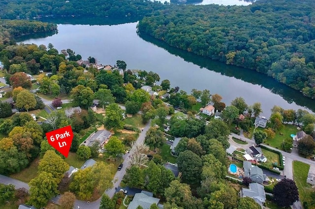 aerial view with a water view and a wooded view