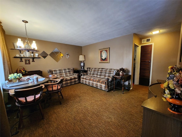 carpeted living room with an inviting chandelier