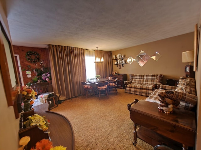 carpeted living room featuring a textured ceiling and wood walls