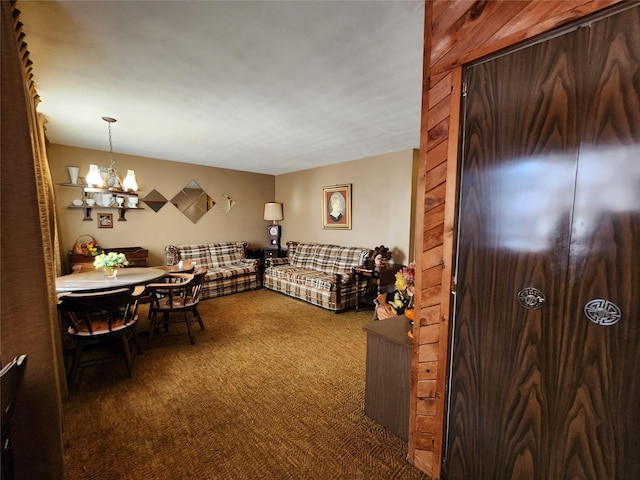 living room featuring a notable chandelier and dark colored carpet