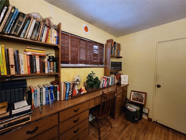 office space with built in desk and wood-type flooring