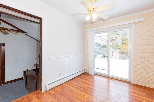 unfurnished room with ceiling fan, light hardwood / wood-style flooring, baseboard heating, and crown molding