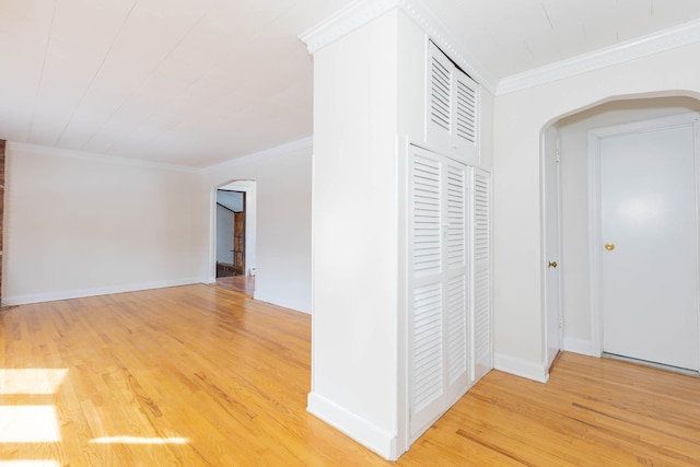 hallway with hardwood / wood-style flooring and ornamental molding