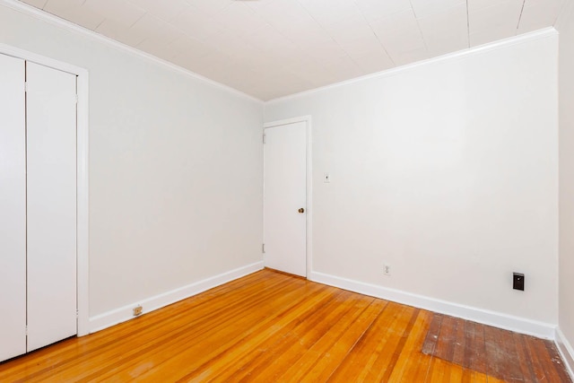 unfurnished room featuring hardwood / wood-style floors and ornamental molding