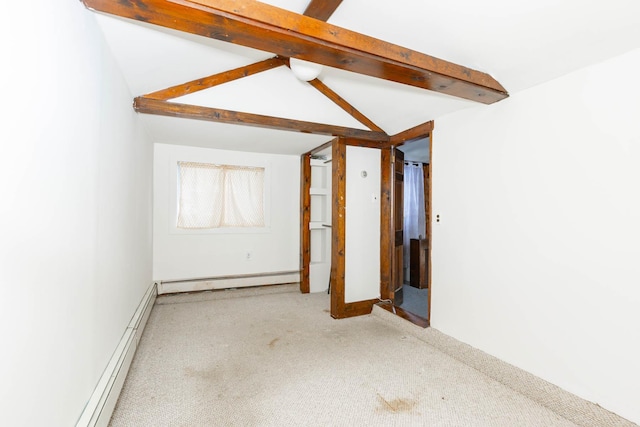 empty room with a baseboard radiator and lofted ceiling with beams