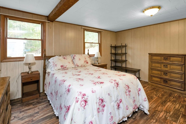 bedroom with multiple windows, wooden walls, and dark hardwood / wood-style floors