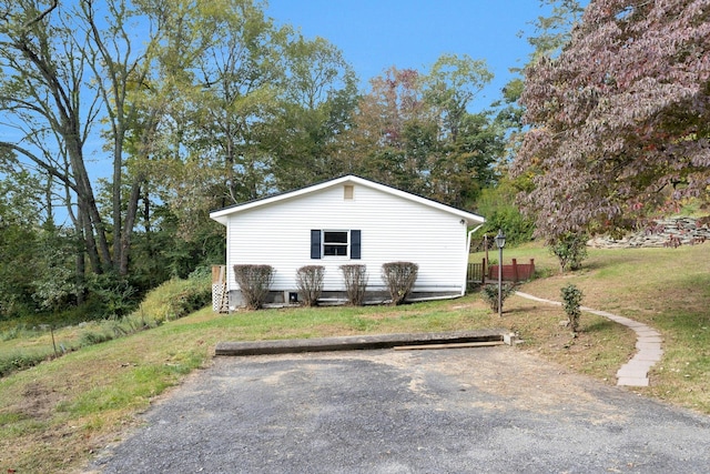 view of side of home with a lawn