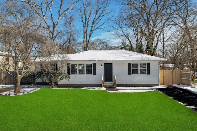 ranch-style home featuring a lawn