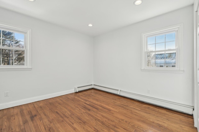 empty room with a baseboard radiator and wood-type flooring