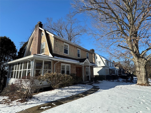 view of front of house with a sunroom