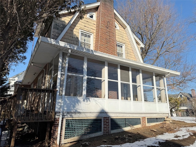 view of property exterior with a sunroom