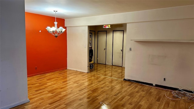 interior space featuring hardwood / wood-style flooring and an inviting chandelier