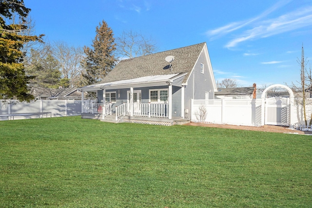 rear view of house featuring a yard and a deck