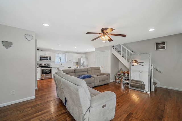 living room featuring sink, dark hardwood / wood-style floors, and ceiling fan