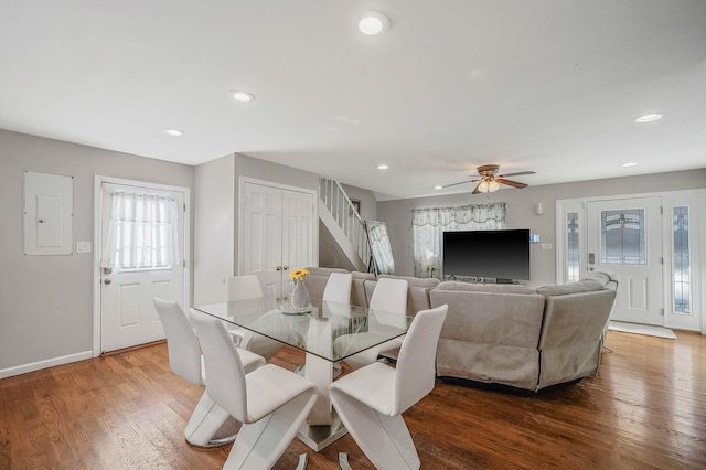 dining room featuring ceiling fan, wood-type flooring, and electric panel