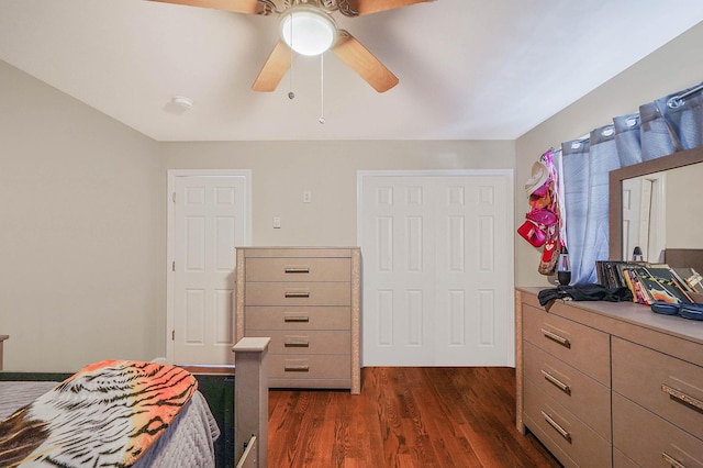 bedroom with dark hardwood / wood-style floors and ceiling fan