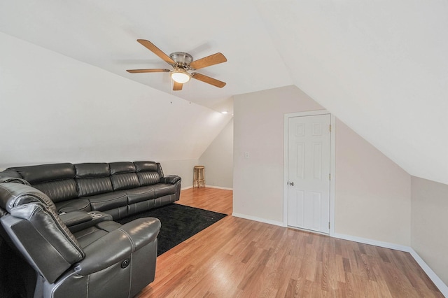 living room with ceiling fan, wood-type flooring, and vaulted ceiling