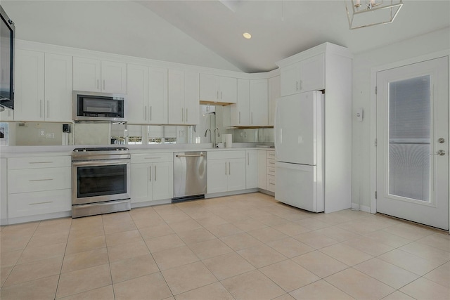 kitchen with white cabinets, appliances with stainless steel finishes, sink, and light tile patterned floors