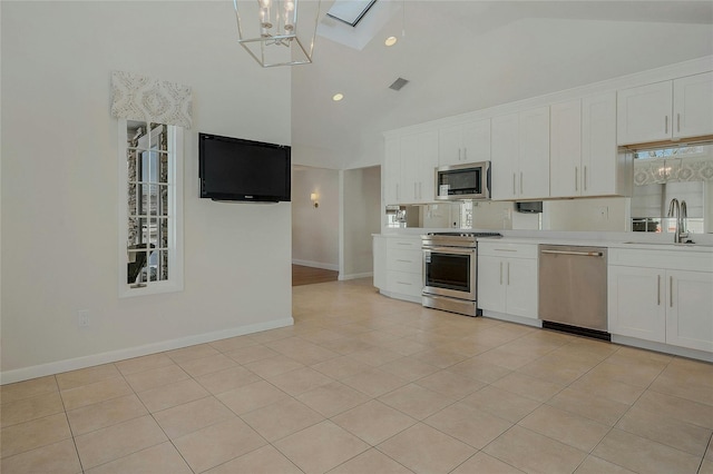 kitchen featuring sink, high vaulted ceiling, light tile patterned floors, appliances with stainless steel finishes, and white cabinets