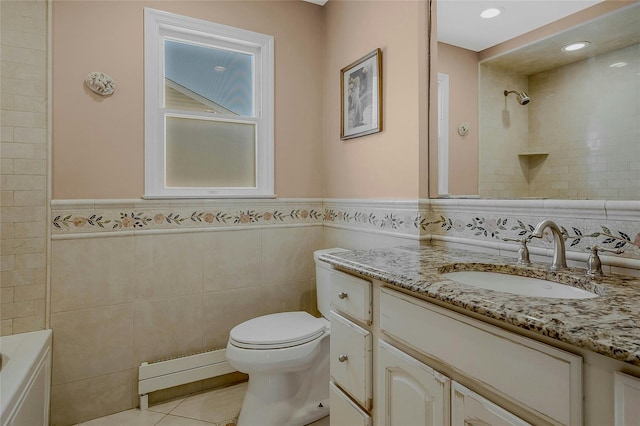 bathroom with tile patterned floors, toilet, tile walls, and vanity