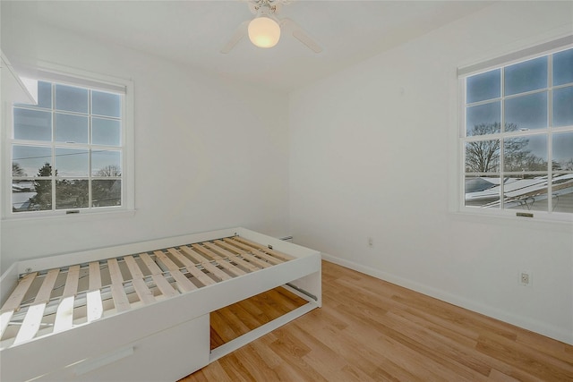 unfurnished bedroom with wood-type flooring and ceiling fan