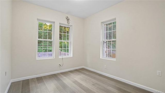 unfurnished room featuring light hardwood / wood-style floors