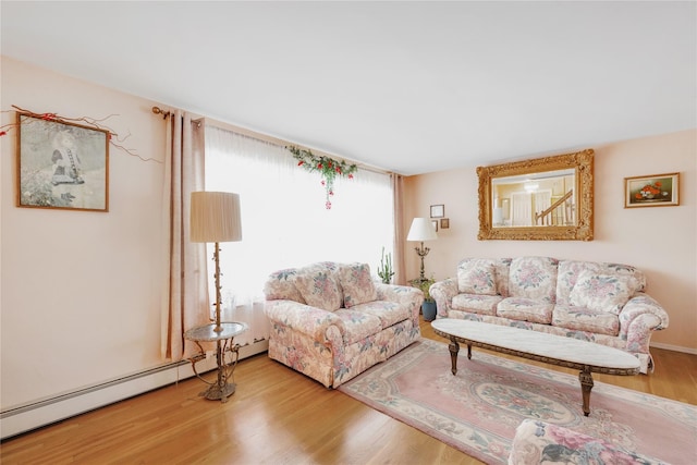 living room with hardwood / wood-style floors and a baseboard heating unit