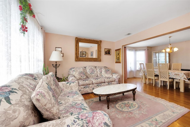 living room with a notable chandelier and hardwood / wood-style floors