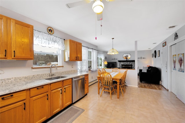 kitchen featuring a baseboard radiator, stainless steel dishwasher, sink, light stone countertops, and a fireplace