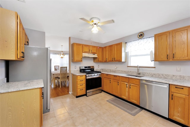 kitchen featuring ceiling fan, sink, a wealth of natural light, and stainless steel appliances