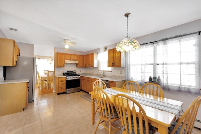 dining space featuring ceiling fan, sink, and baseboard heating