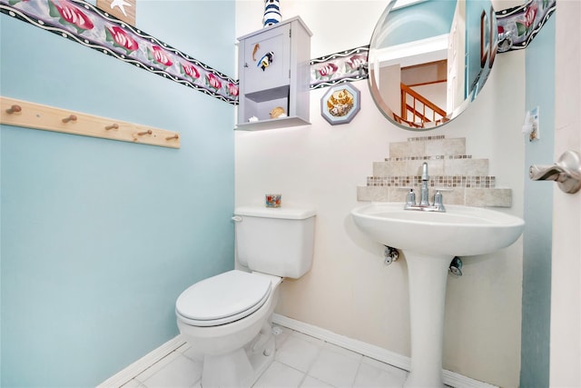 bathroom with decorative backsplash, sink, toilet, and tile patterned flooring