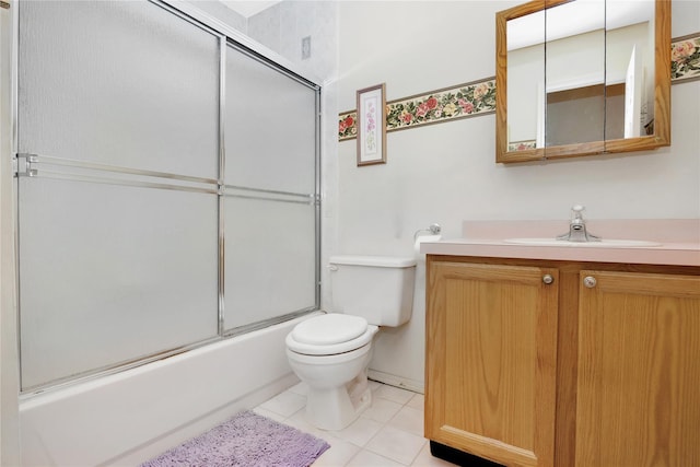 full bathroom with bath / shower combo with glass door, toilet, tile patterned floors, and vanity