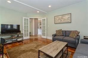 living room featuring dark hardwood / wood-style flooring and french doors