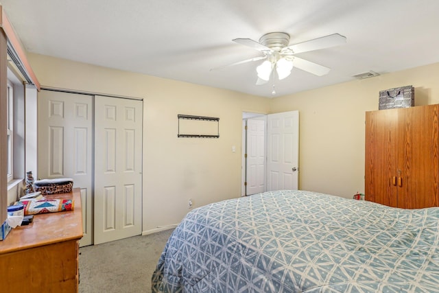 carpeted bedroom with a closet and ceiling fan