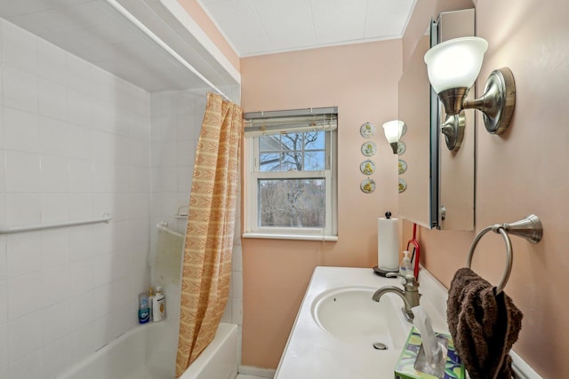 bathroom with crown molding, shower / bath combo with shower curtain, and vanity