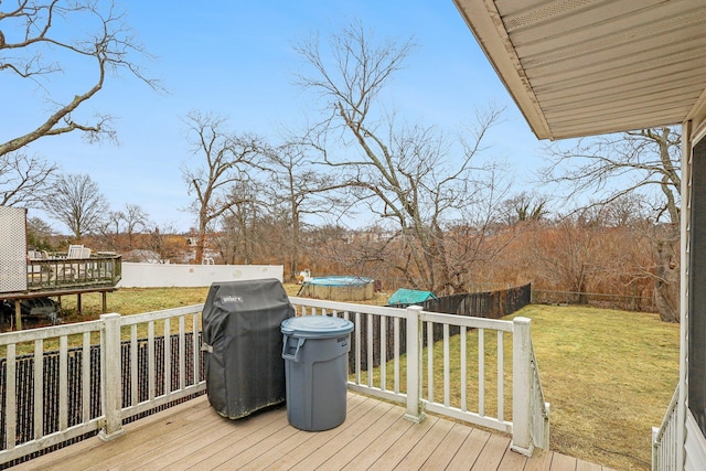 wooden terrace with a pool and a lawn