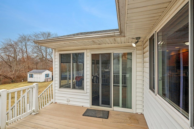 wooden terrace with a storage shed