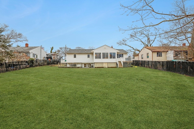 back of house with a lawn