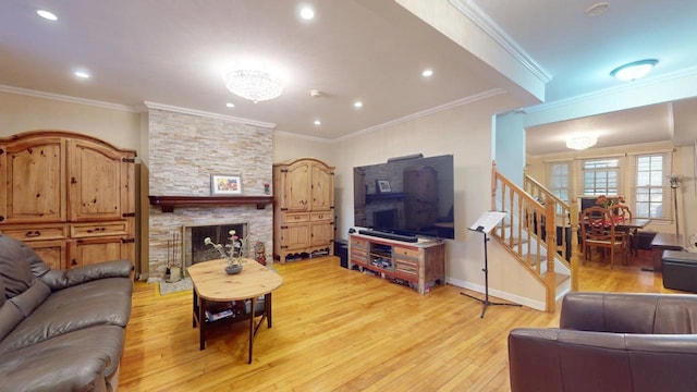 living room featuring a fireplace, crown molding, and light hardwood / wood-style flooring