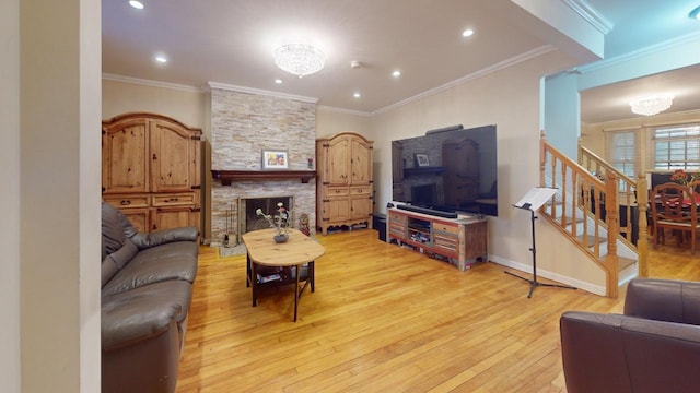 living room with ornamental molding, a fireplace, and light hardwood / wood-style flooring