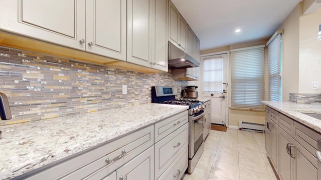 kitchen featuring light tile patterned floors, stainless steel gas range, a baseboard heating unit, tasteful backsplash, and light stone counters