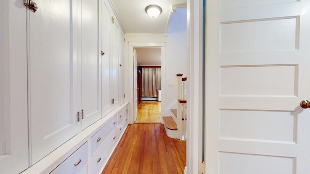 hallway featuring light wood-type flooring and baseboard heating