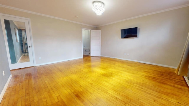 unfurnished room with crown molding and light hardwood / wood-style floors