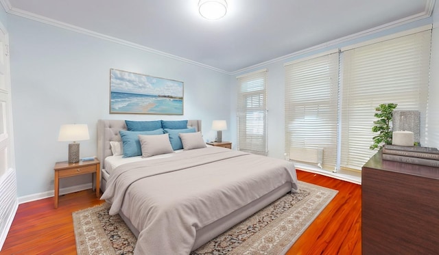 bedroom featuring wood-type flooring and ornamental molding