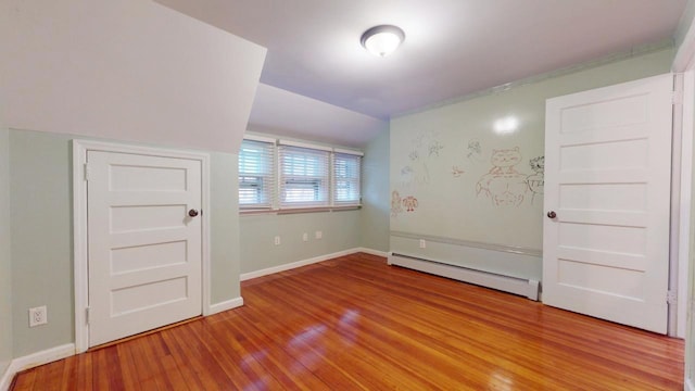 spare room featuring light wood-type flooring and a baseboard heating unit