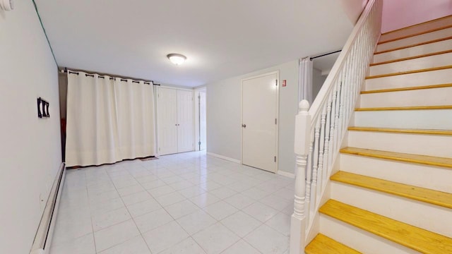 stairs featuring a baseboard heating unit