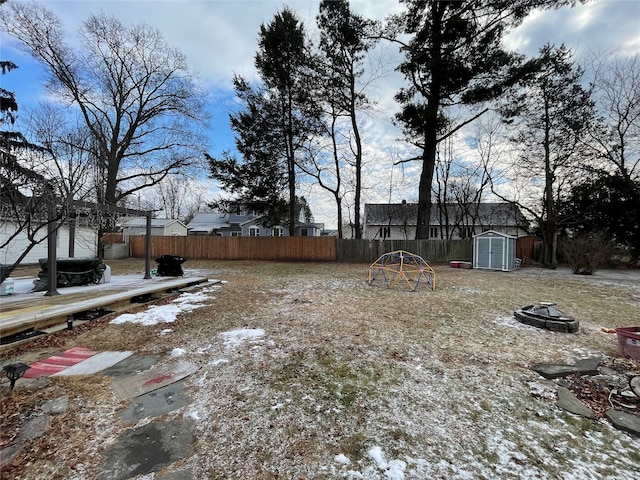 view of yard with an outdoor fire pit and a shed