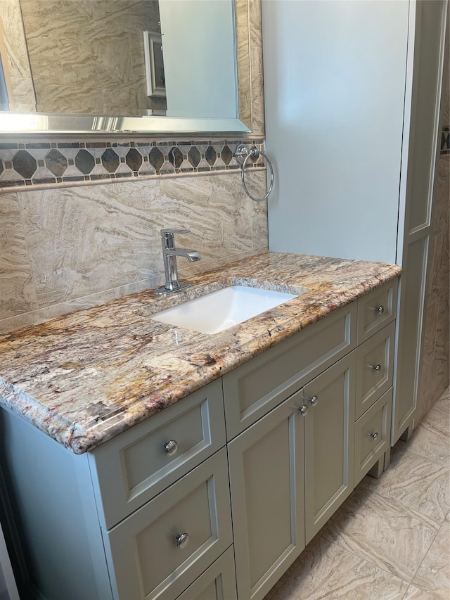 bathroom featuring decorative backsplash and vanity